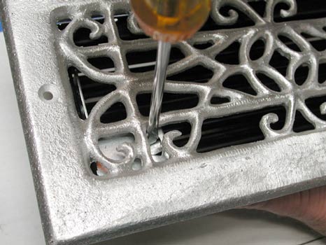 opening an opera grille louver with a screwdriver